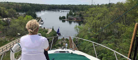 A woman looking over the bow of her boat while on a lift