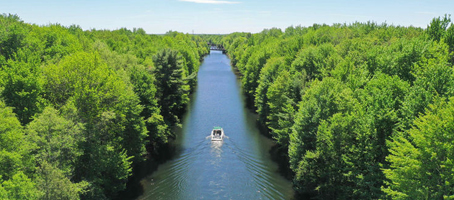 A boat traveling through a river or canal in Ontario